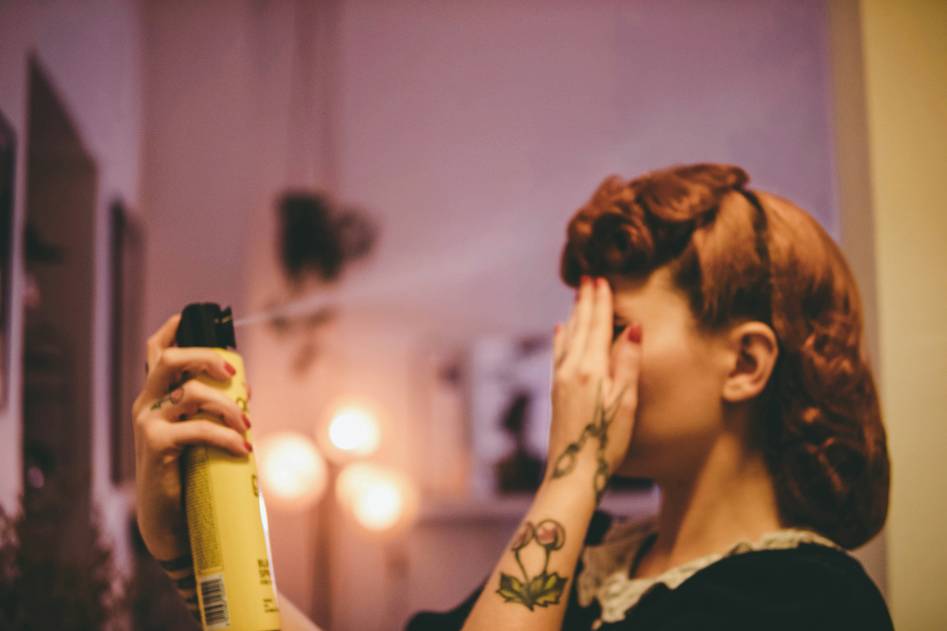 Editorial-style photo of diverse hair textures with open conditioner bottles on a marble surface