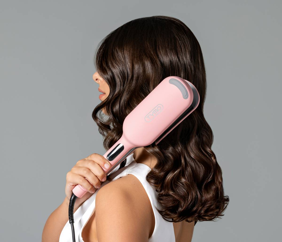 Woman gently applying hair detangling solution to wet, knotted hair in the shower